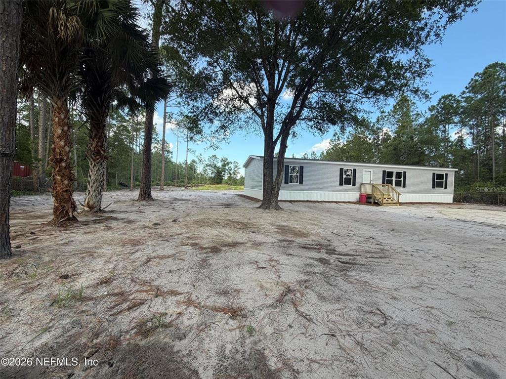 114 Nutmeg Trail Interlachen, FL 32148 - Photo 32 of 33 a view of house with trees in the background