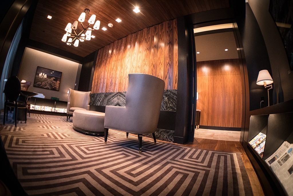 1 Franklin Street, Unit PH 2D Boston, MA 02110 - Photo 15 of 26 a living room with furniture and a chandelier