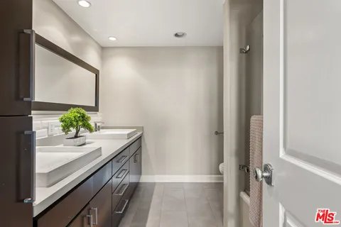 a bath room with a sink and a mirror