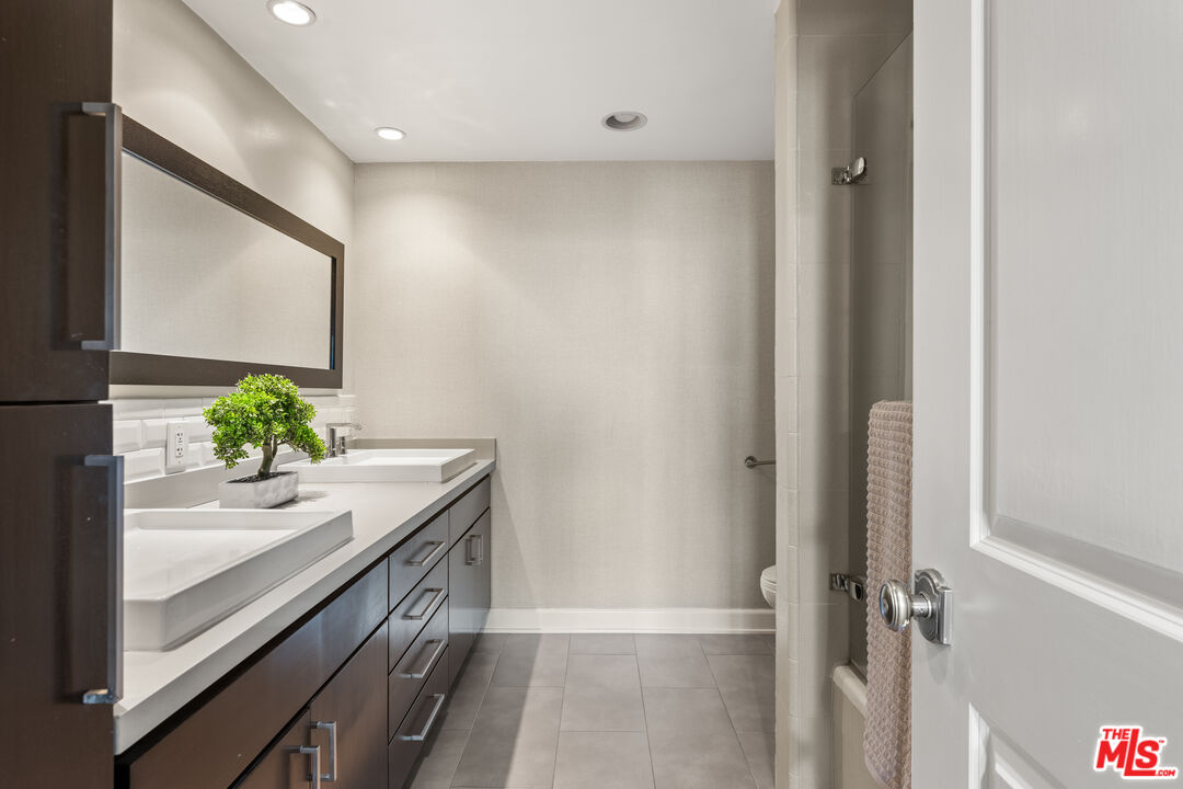 1333 South Beverly Glen Boulevard, Unit 703 Los Angeles, CA 90024 - Photo 13 of 18 a bath room with a sink and a mirror
