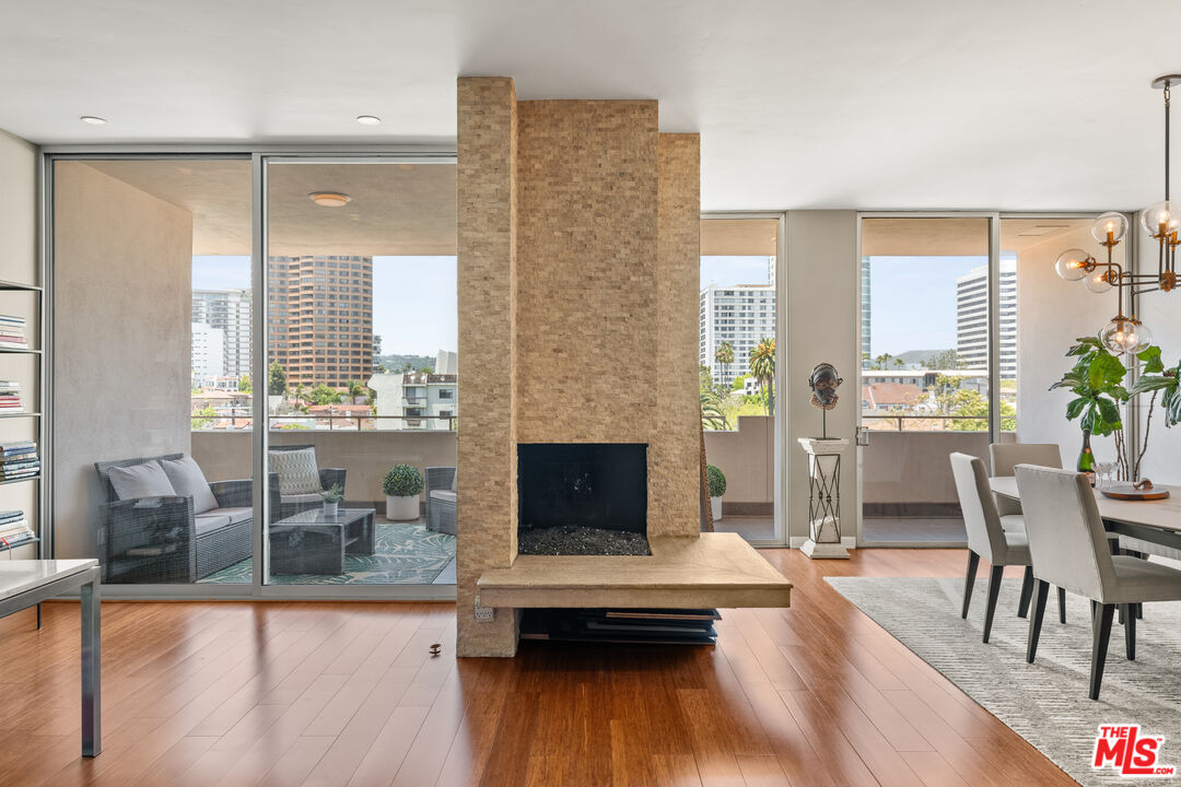 1333 South Beverly Glen Boulevard, Unit 703 Los Angeles, CA 90024 - Photo 2 of 18 a living room with furniture and wooden floor