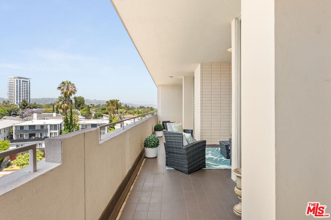 1333 South Beverly Glen Boulevard, Unit 703 Los Angeles, CA 90024 - Photo 4 of 18 a kitchen with stainless steel appliances kitchen island granite countertop lots of counter top space