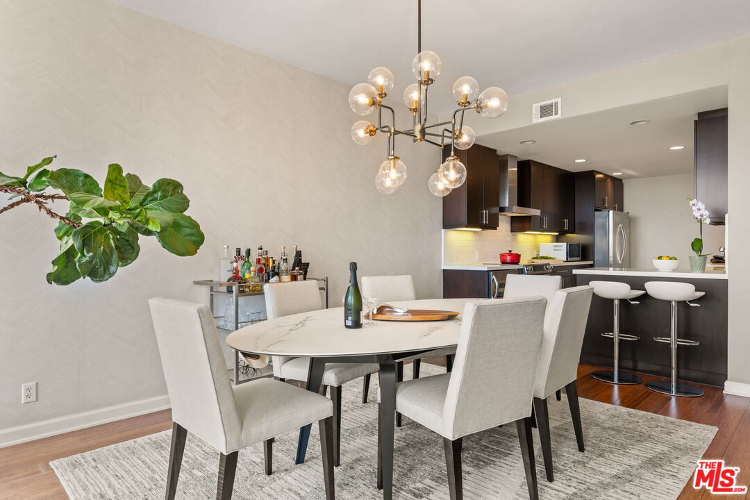 1333 South Beverly Glen Boulevard, Unit 703 Los Angeles, CA 90024 - Photo 7 of 18 a view of a dining room with furniture and wooden floor