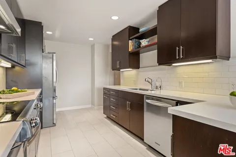 a kitchen with a sink cabinets and stainless steel appliances