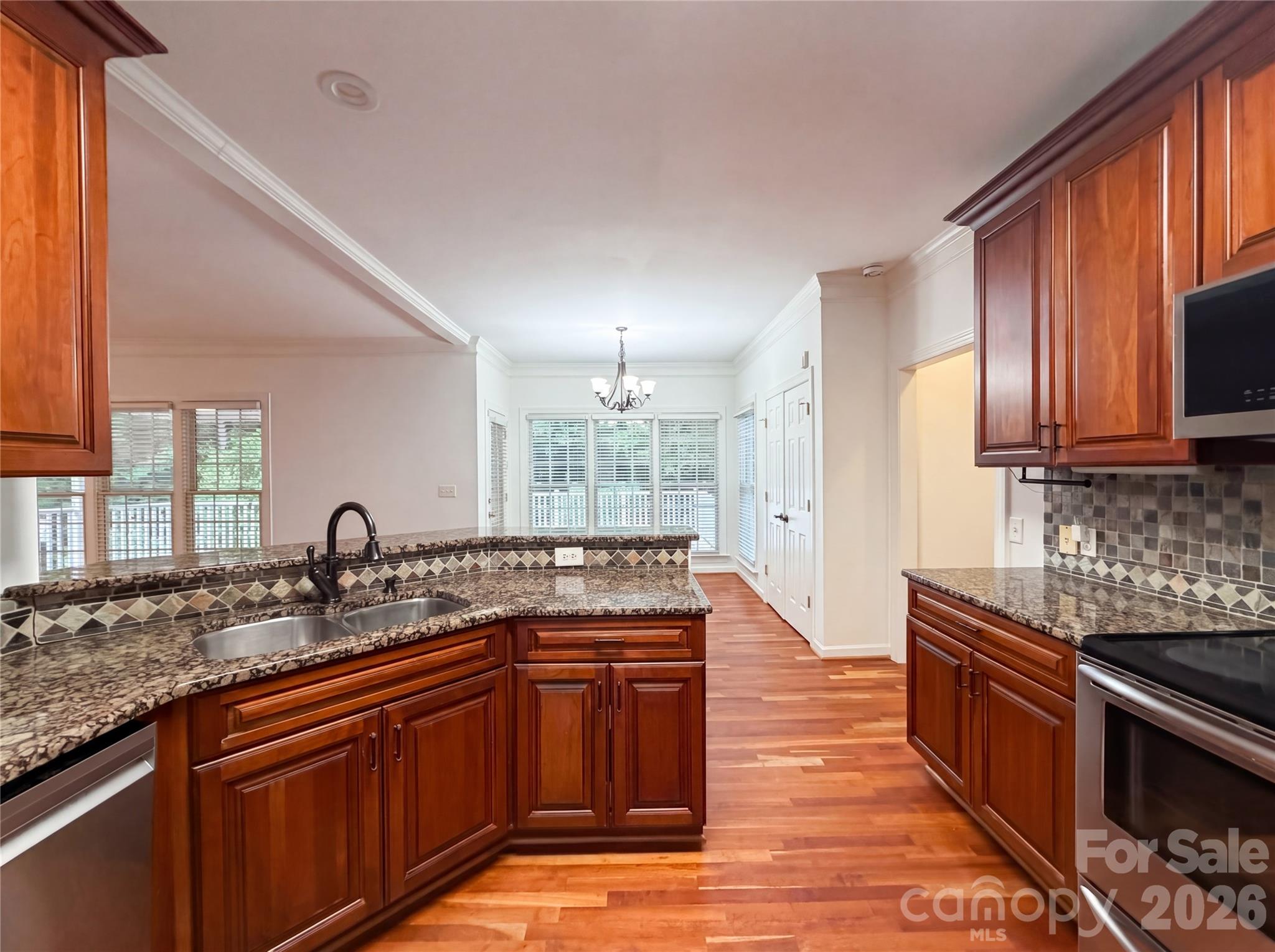 12341 Willingdon Road Huntersville, NC 28078 - Photo 7 of 17 a kitchen with granite countertop a sink stove and cabinets