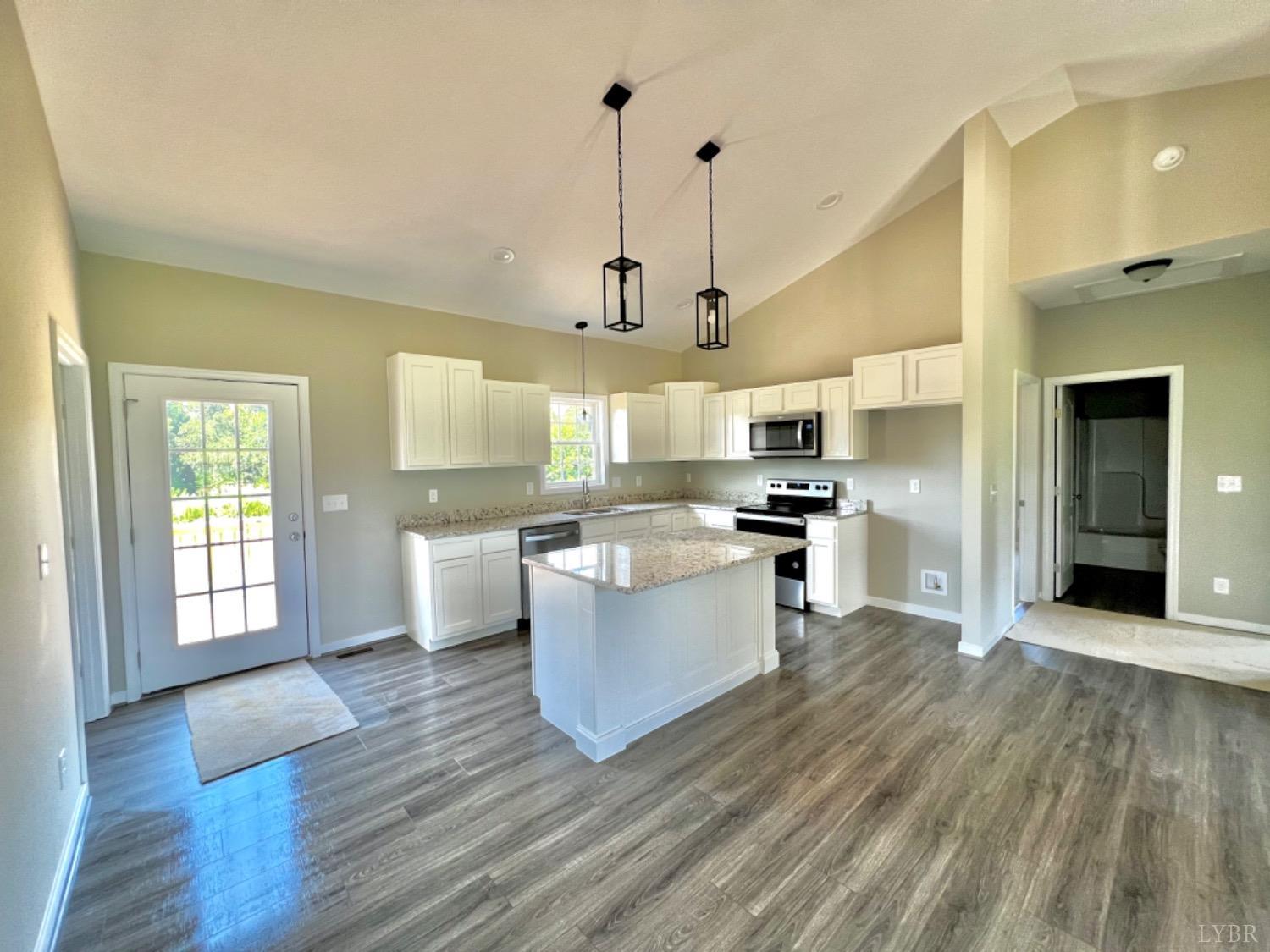 4922 Worsham Road Green Bay, VA 23942 - Photo 6 of 15 a kitchen with kitchen island white cabinets and stainless steel appliances
