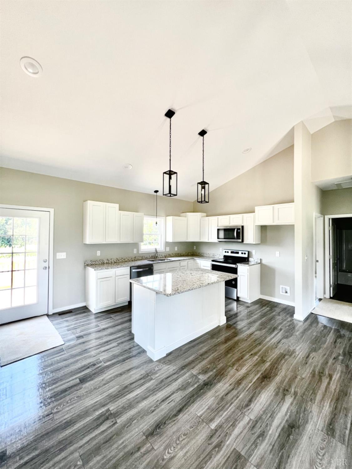 4922 Worsham Road Green Bay, VA 23942 - Photo 7 of 15 a kitchen with a sink and white cabinets with wooden floor