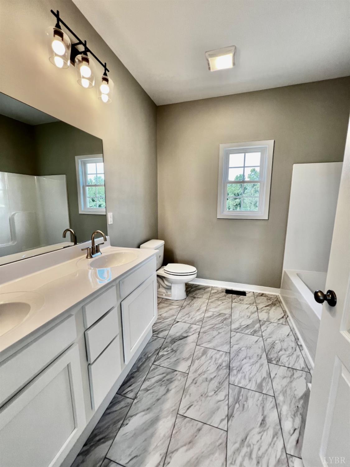 4922 Worsham Road Green Bay, VA 23942 - Photo 9 of 15 a spacious bathroom with a double vanity sink and a mirror