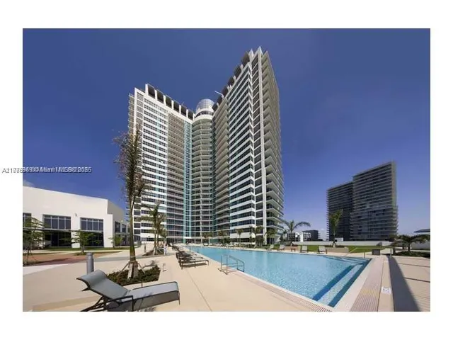 a view of a swimming pool with chairs