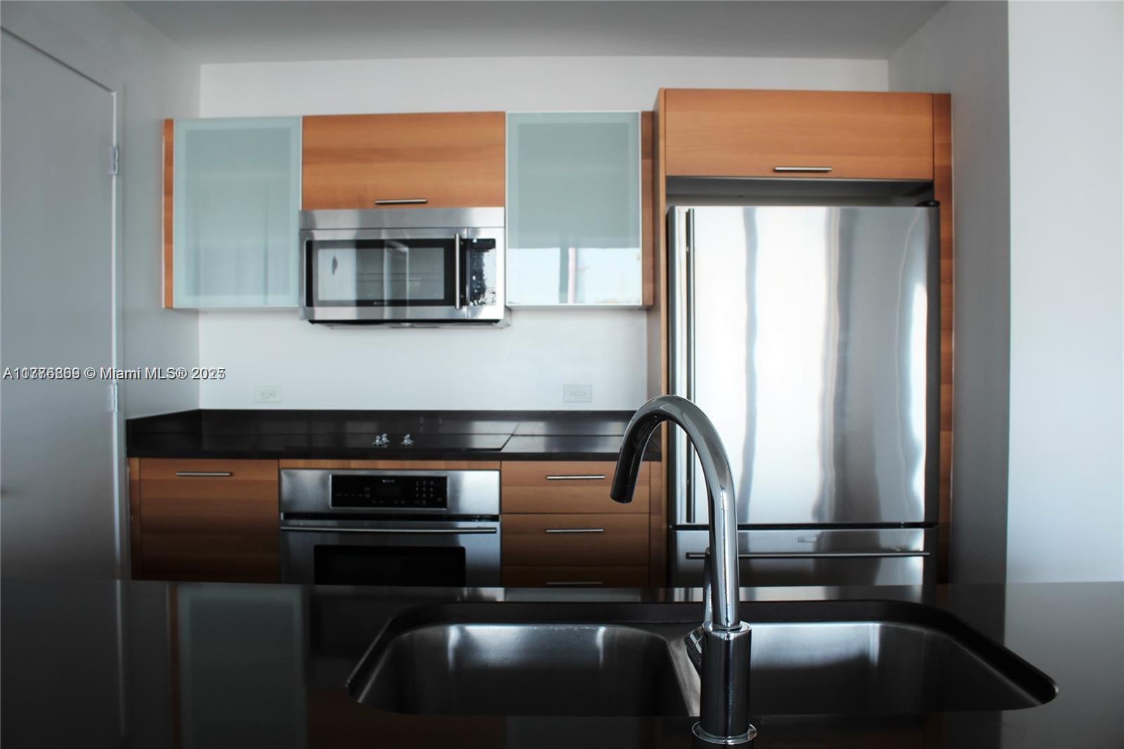 3301 Northeast 1st Avenue, Unit H2904 Miami, FL 33137 - Photo 6 of 15 a kitchen with a refrigerator and stove