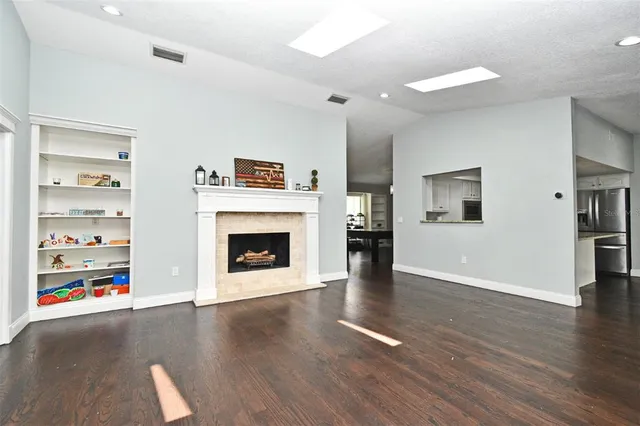 a view of a livingroom with a fireplace a fireplace and wooden floor