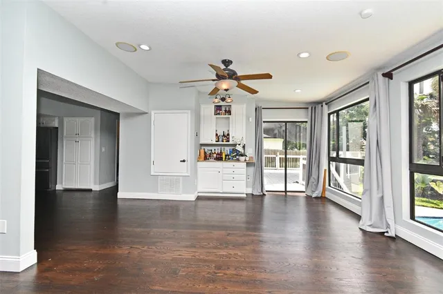 a view of a livingroom with wooden floor and a flat screen tv
