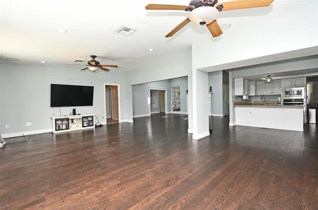 a kitchen with kitchen island granite countertop a sink cabinets and stainless steel appliances