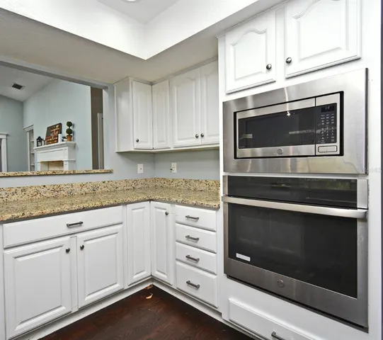 a kitchen with a sink stove and microwave