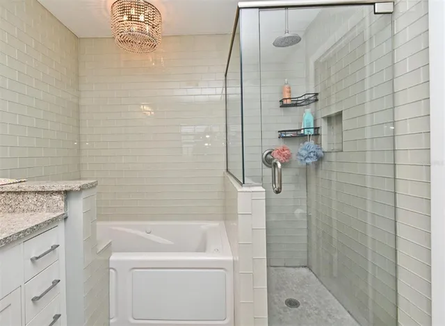 a bedroom with a bed chandelier and a window