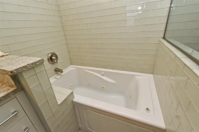 a bedroom with a bed lamp and a window