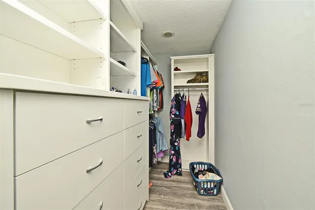 a view of a bedroom with wooden floor