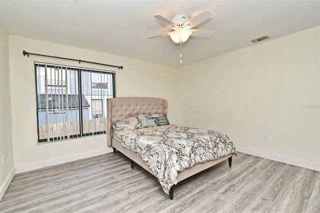 a view of a house with pool fire pit couches and chairs