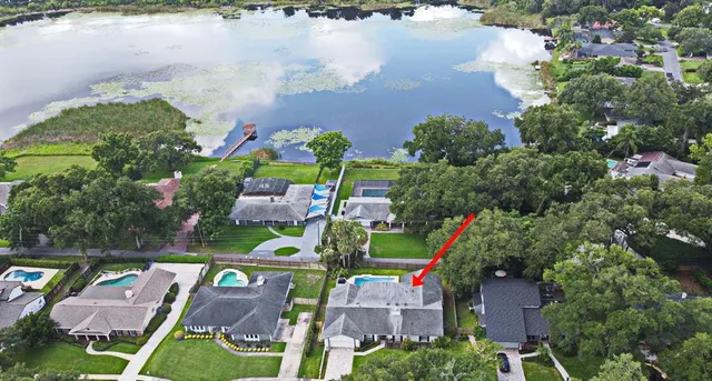 an aerial view of house with yard swimming pool and outdoor seating