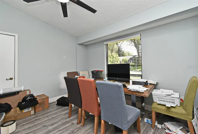 a view of a workspace with furniture and a window
