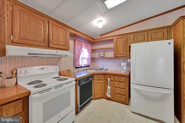 a white refrigerator freezer sitting inside of a kitchen