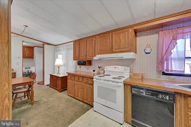 a kitchen with a stove a sink and a refrigerator