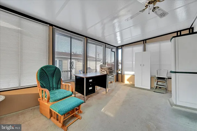 a living room with furniture and large windows