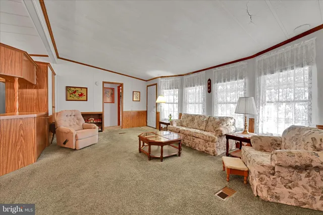 a living room with furniture and large windows