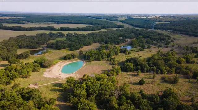 an aerial view of residential houses with outdoor space and river