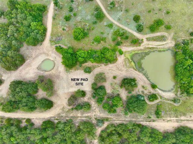 an aerial view of a house with a yard and garden