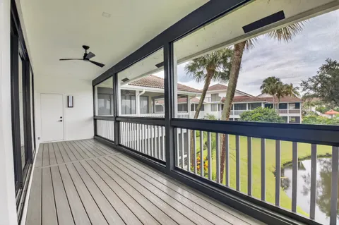 a view of a balcony with wooden floor