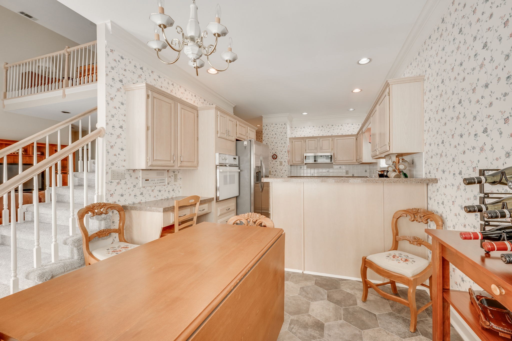 1705 Fieldcrest Circle Franklin, TN 37064 - Photo 20 of 45 a kitchen with stainless steel appliances granite countertop a sink a stove a refrigerator cabinets and living room view