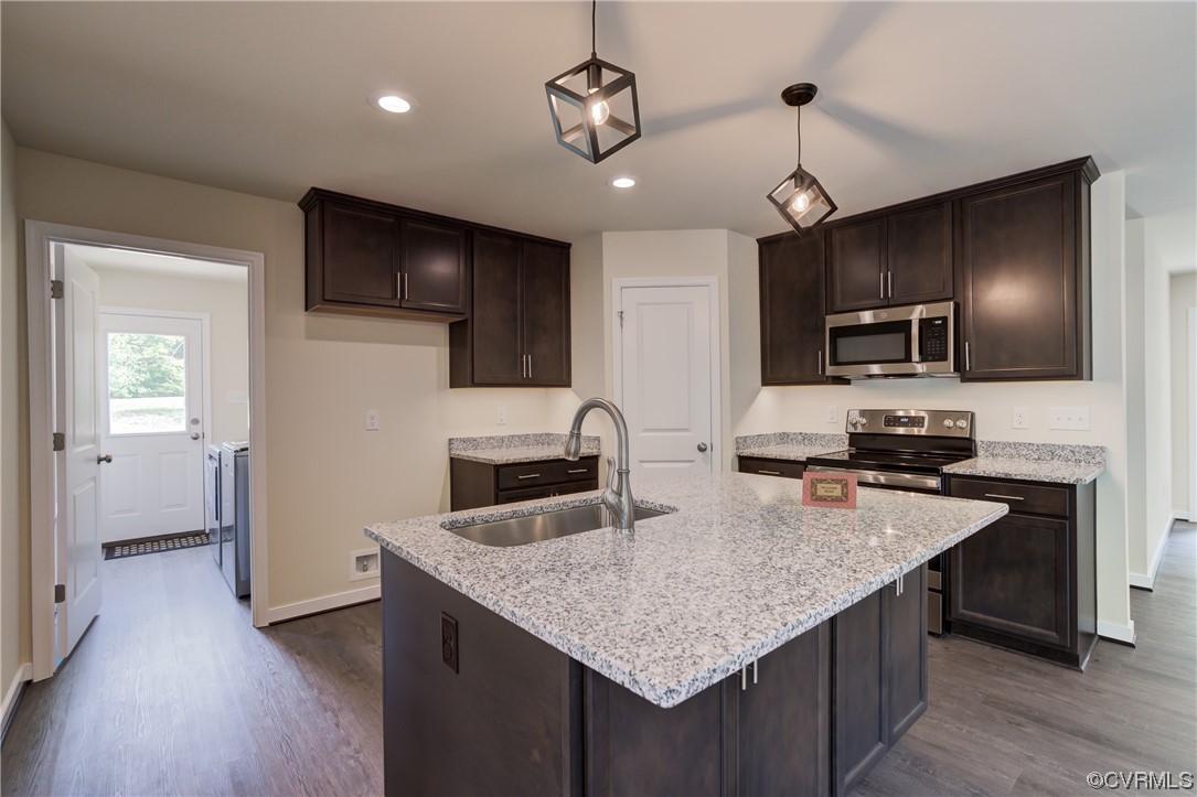 400 New S Ridge Road Bumpass, VA 23024 - Photo 15 of 41 a kitchen with granite countertop stainless steel appliances a sink stove and refrigerator