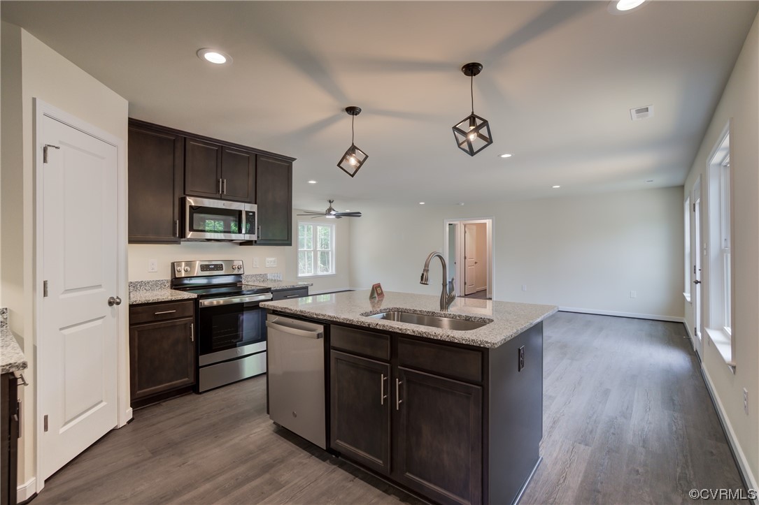 400 New S Ridge Road Bumpass, VA 23024 - Photo 16 of 41 a kitchen with a sink stainless steel appliances and wooden floor