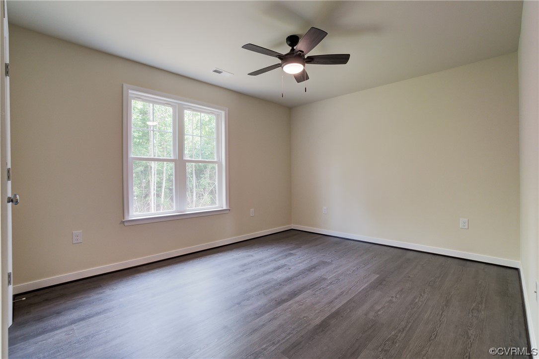 400 New S Ridge Road Bumpass, VA 23024 - Photo 22 of 41 an empty room with wooden floor chandelier fan and windows