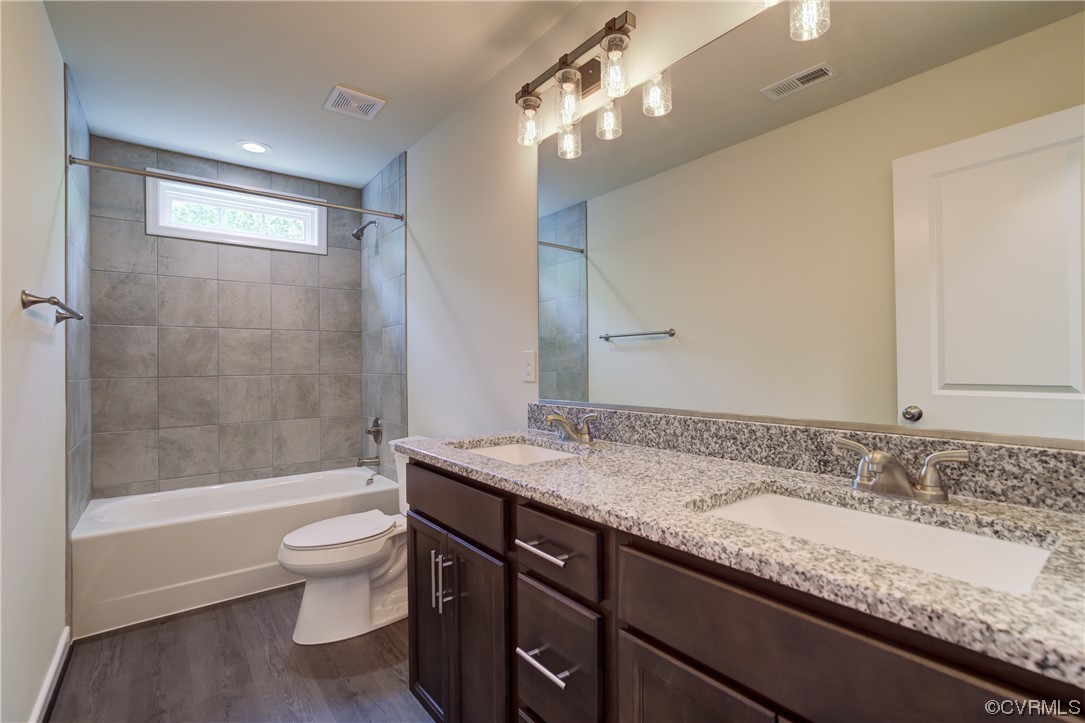 400 New S Ridge Road Bumpass, VA 23024 - Photo 23 of 41 a bathroom with a granite countertop sink a toilet and bathtub