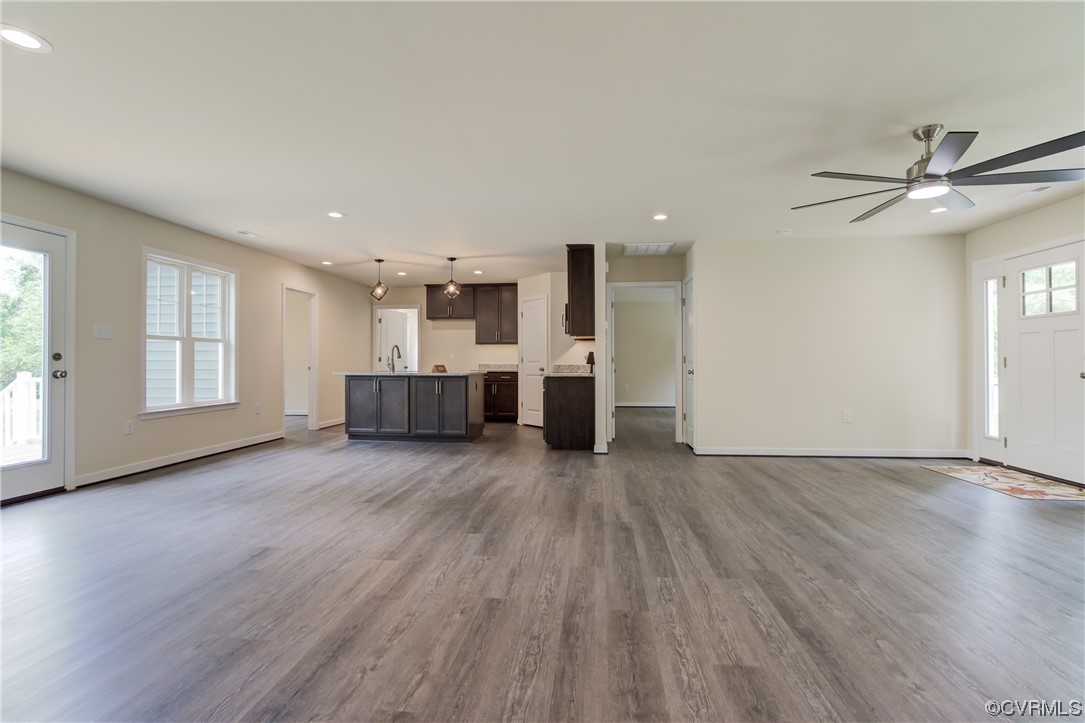 400 New S Ridge Road Bumpass, VA 23024 - Photo 24 of 41 a big room with wooden floors and kitchen view