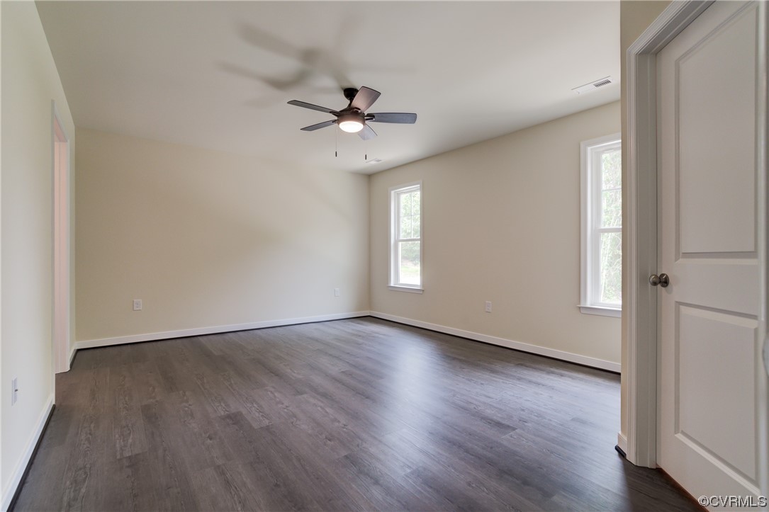 400 New S Ridge Road Bumpass, VA 23024 - Photo 25 of 41 an empty room with wooden floor fan and windows