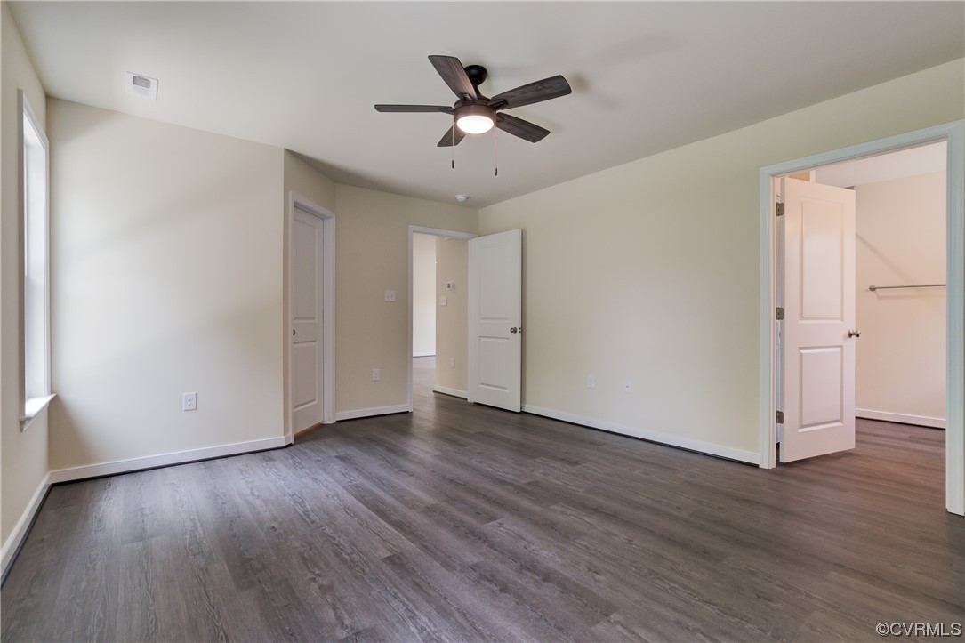 400 New S Ridge Road Bumpass, VA 23024 - Photo 26 of 41 an empty room with wooden floor and ceiling fan