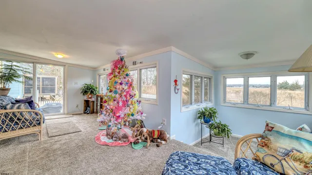 a living room with furniture and flowers