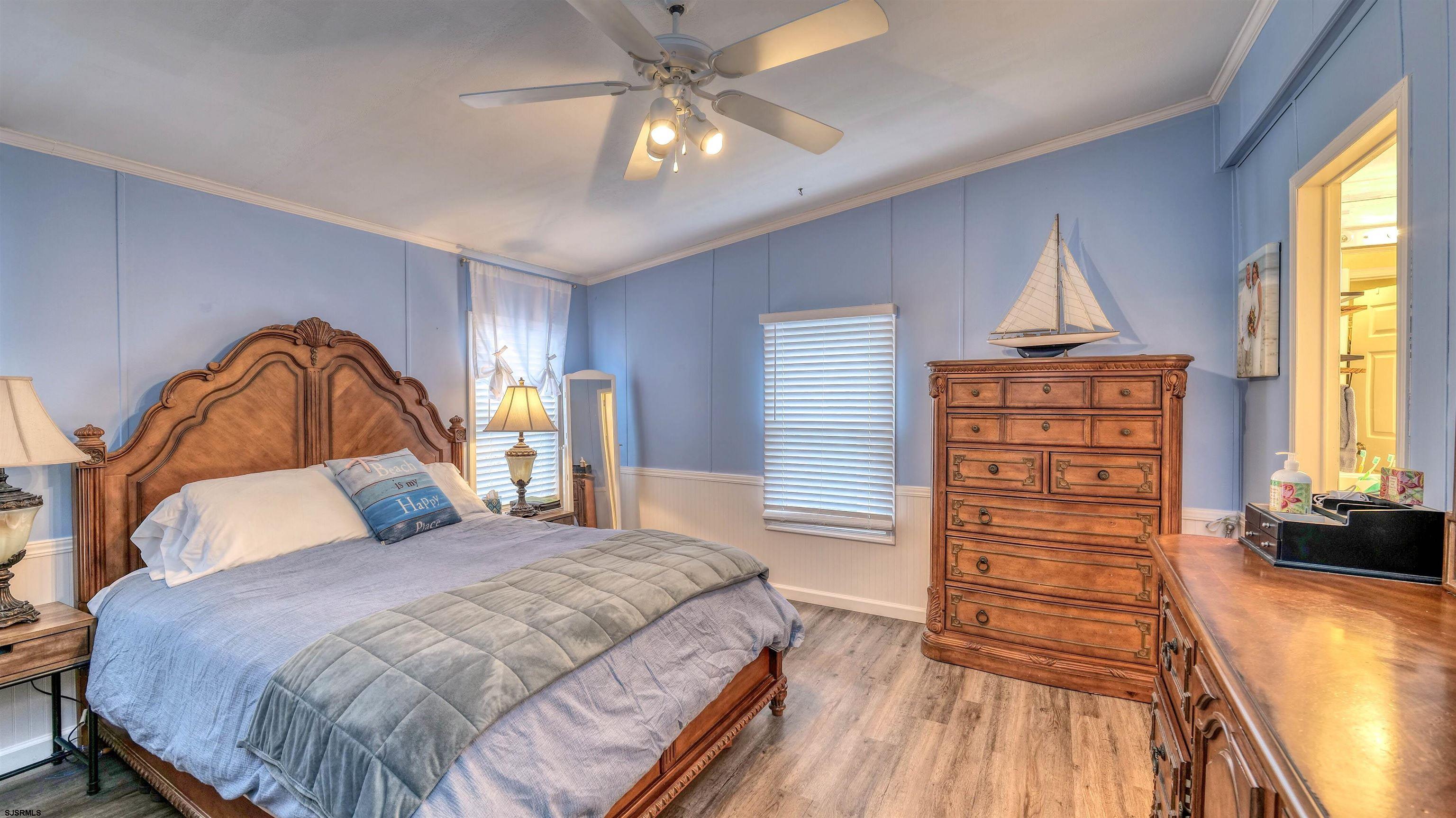 33 Defeo Lane Somers Point, NJ 08244 - Photo 14 of 29 a bedroom with a large bed and a chandelier