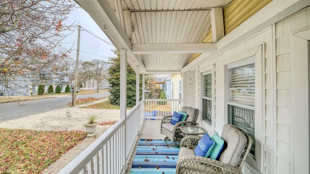 a living room with furniture and a floor to ceiling window
