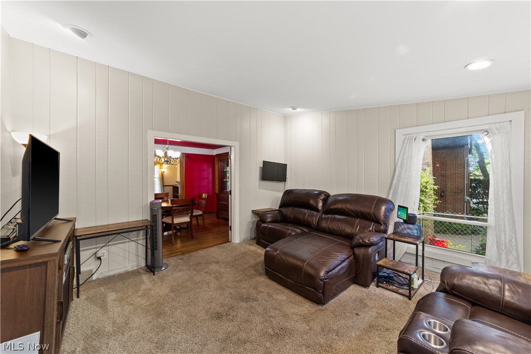 1237 Yellowstone Road Cleveland, OH 44121 - Photo 19 of 48 Living room featuring carpet and a chandelier
