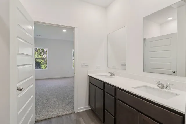 a bathroom with a double vanity sink and a mirror