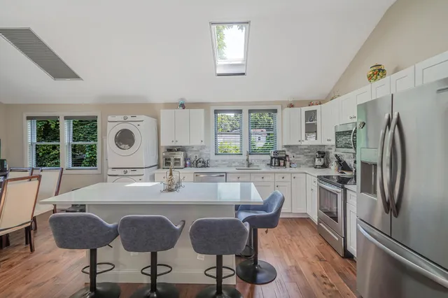 a kitchen with granite countertop a sink and refrigerator