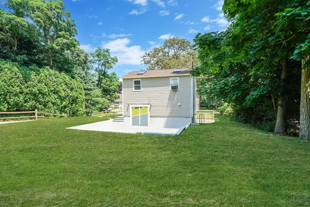 a view of a house with a yard and a garden