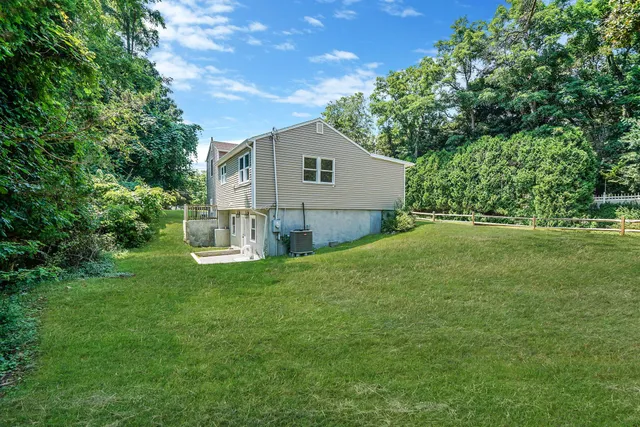 a house with green field in front of it