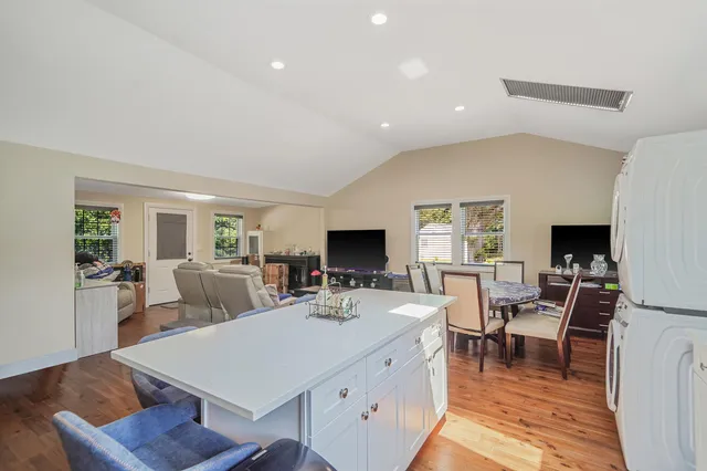 a living room with furniture a flat screen tv and a large window