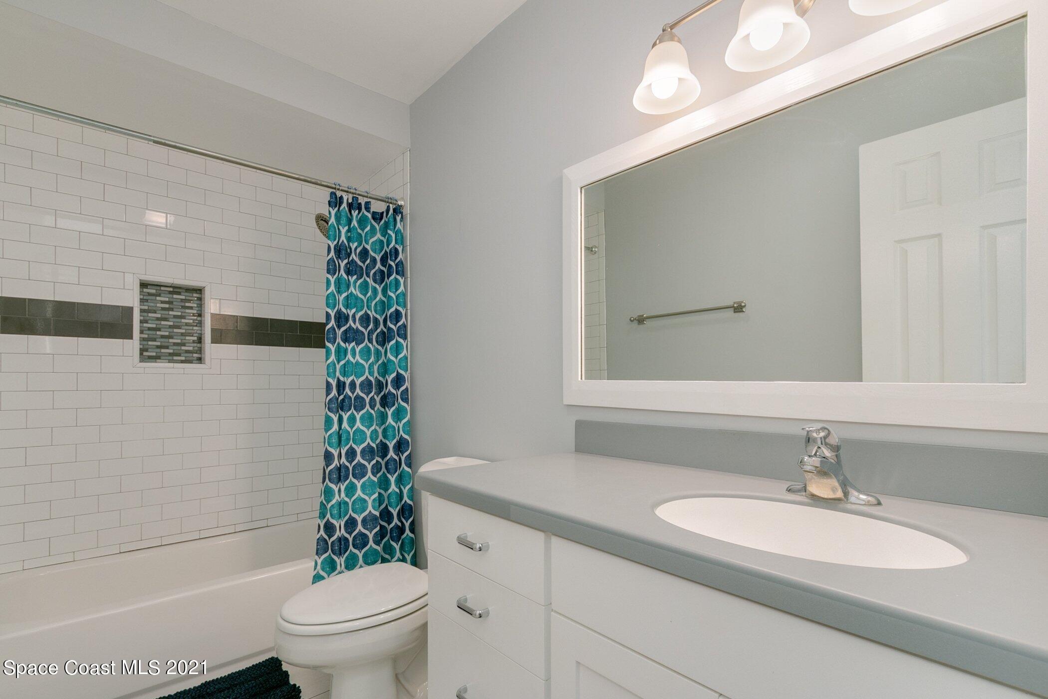 1589 Magnolia Street Northeast Palm Bay, FL 32905 - Photo 15 of 16 a bathroom with a sink toilet and shower