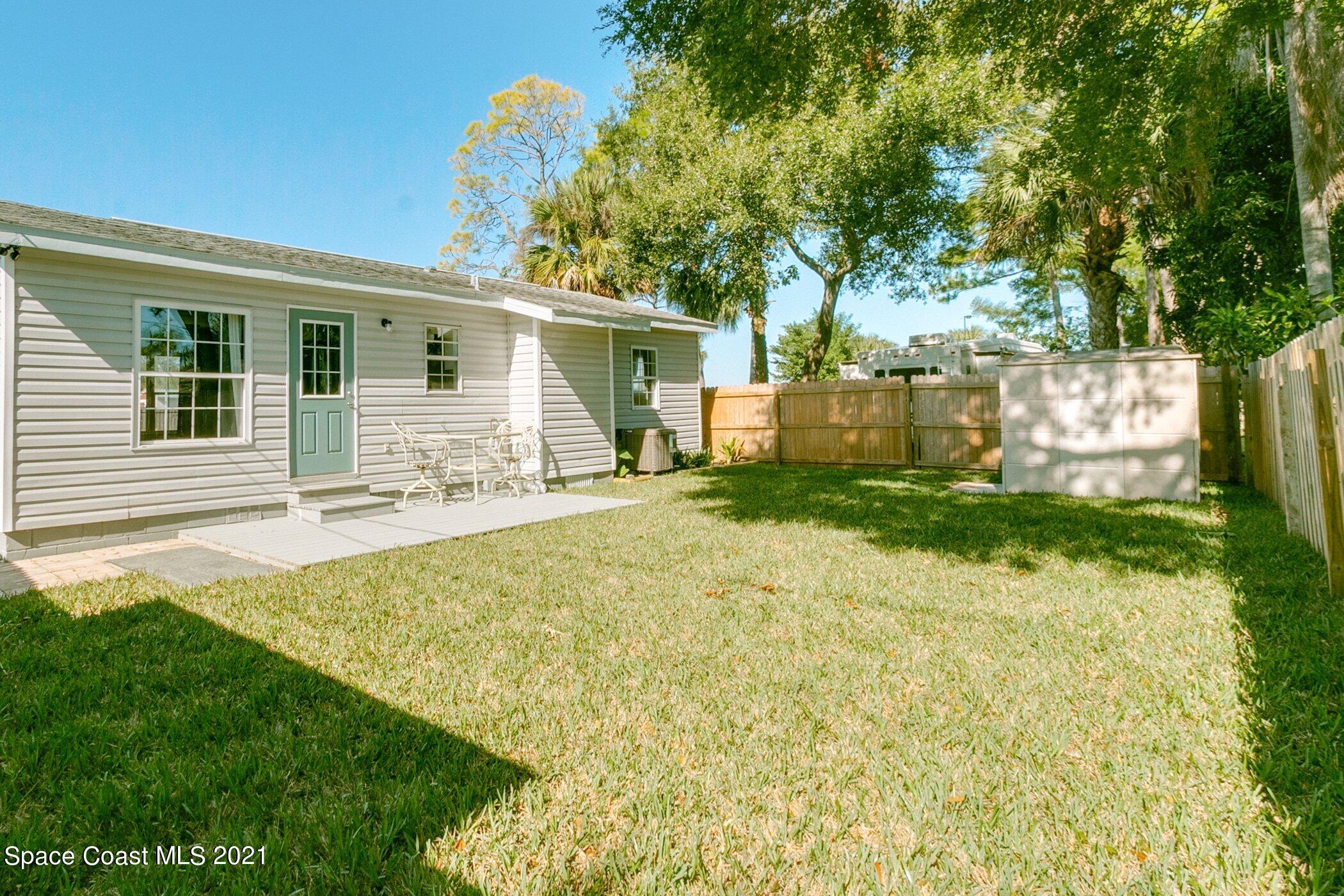 1589 Magnolia Street Northeast Palm Bay, FL 32905 - Photo 4 of 16 a view of a house with backyard and a tree